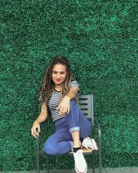 Full length of woman sitting on grass