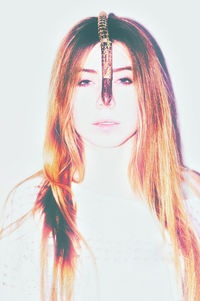 Close-up portrait of beautiful young woman over white background