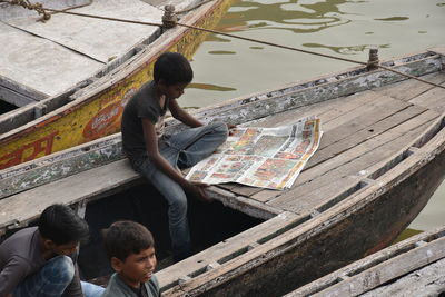 High angle view of people sitting by water