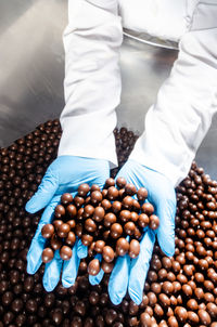 Hazelnuts wrapped in chocolate in the manufacturing pot