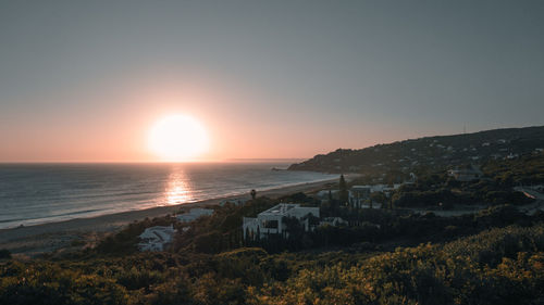 Scenic view of sea against clear sky during sunset