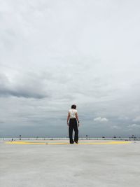 Full length of man standing on field against sky