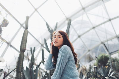 Portrait of young woman looking away outdoors