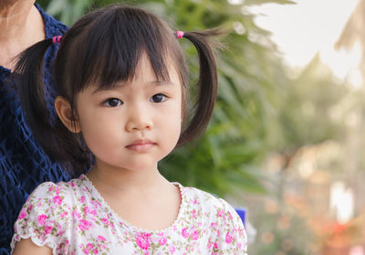 Close-up portrait of cute girl standing outdoors