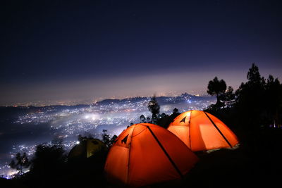 Tent on field against sky at night