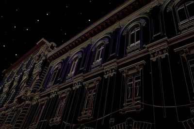 Low angle view of illuminated building at night