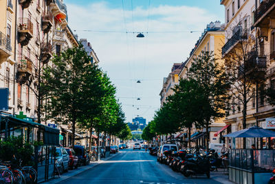 Street amidst buildings in city against sky