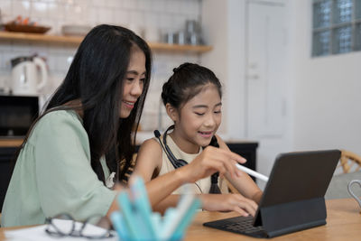 Young woman using laptop at home