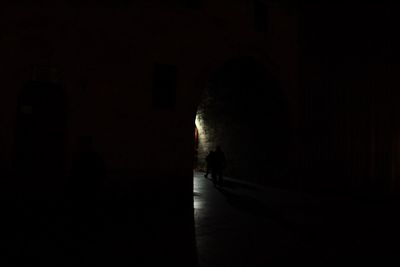 Silhouette man in illuminated room