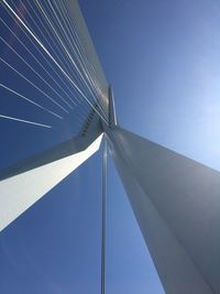 Low angle view of suspension bridge against clear blue sky