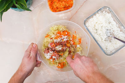 Cropped hand of person preparing food