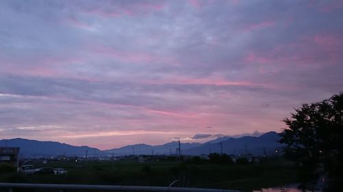 Scenic view of silhouette mountains against sky at sunset