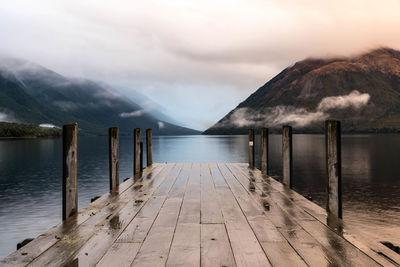 Pier over lake against sky