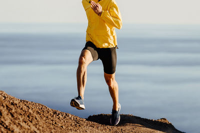 Low section of man running on mountain