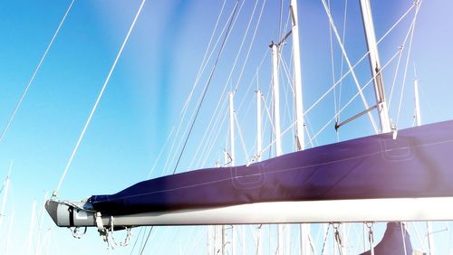 Low angle view of sailboat against blue sky