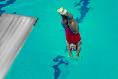 High angle view of swimmer diving into swimming pool