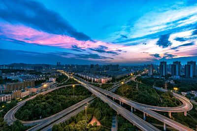 High angle view of illuminated city street against sky