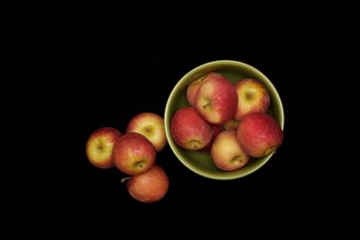 Close-up of apples and fruits against black background