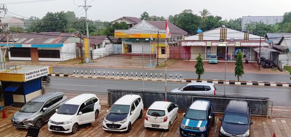 High angle view of cars on street by buildings