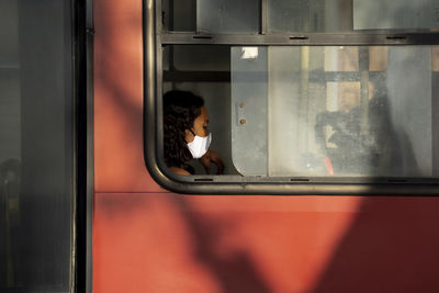 Reflection of woman sitting in train