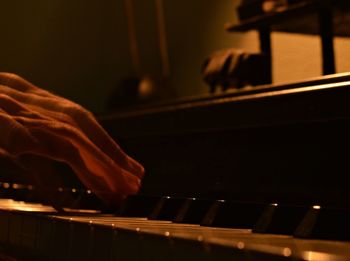 Close-up of hands playing piano