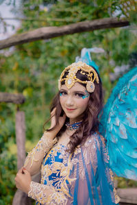 Portrait of young woman in traditional clothing standing outdoors