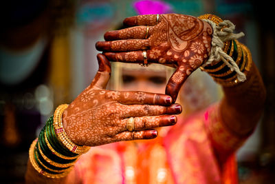 Close-up of human hand against statue