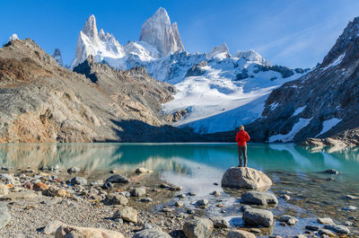 Scenic view of snowcapped mountains by lake against sky