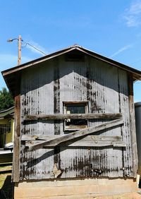 Low angle view of old abandoned building against sky