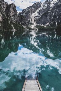 Scenic view of lake by mountain against sky