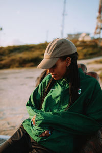 Side view of man sitting on field