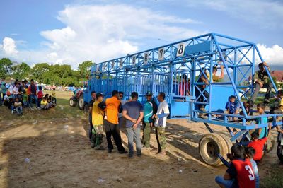 Group of people in front of built structure against sky