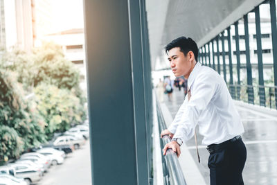 Young man standing against wall