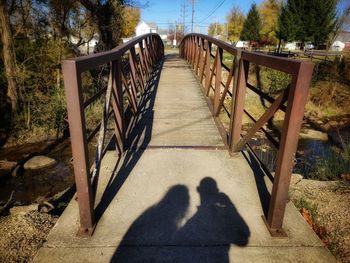 Shadow of people on footbridge