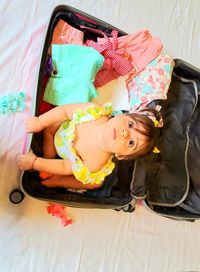 High angle view of girl relaxing on bed at home