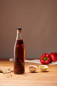 Chili pepper olive oil bottle on table