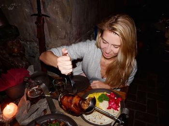 Woman eating food on table 