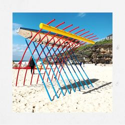 Lifeguard hut on beach against blue sky