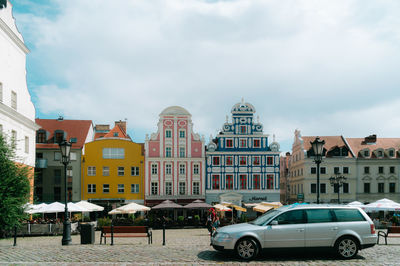 Cars on street against sky