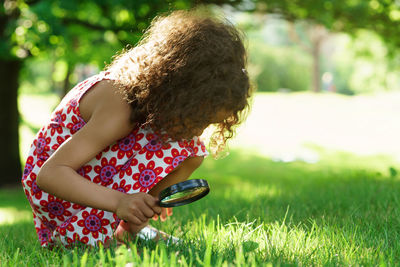 Side view of young woman using mobile phone