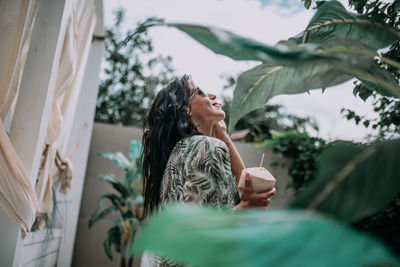 Rear view of woman looking at plants