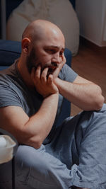 Portrait of young man sitting at home