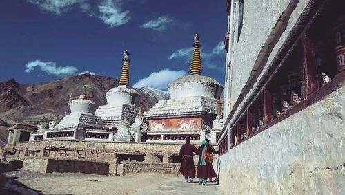 Statue in temple against cloudy sky