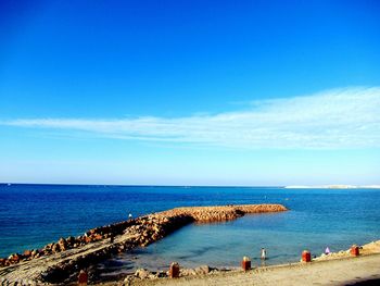 Scenic view of sea against blue sky