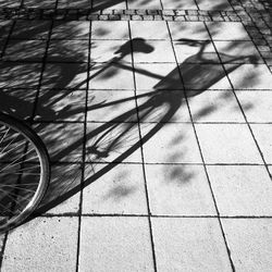 High angle view of shadow on bicycle