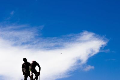 Men standing against sky