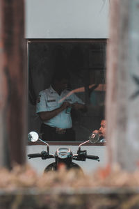 People working in glass window