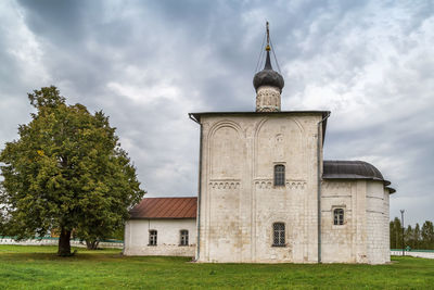 Built structure on field against sky