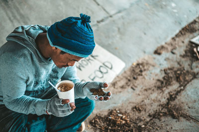 High angle view of man holding coffee