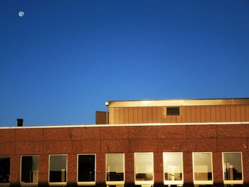 Low angle view of building against clear blue sky